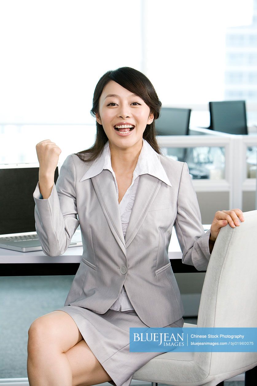 Chinese office worker at her desk