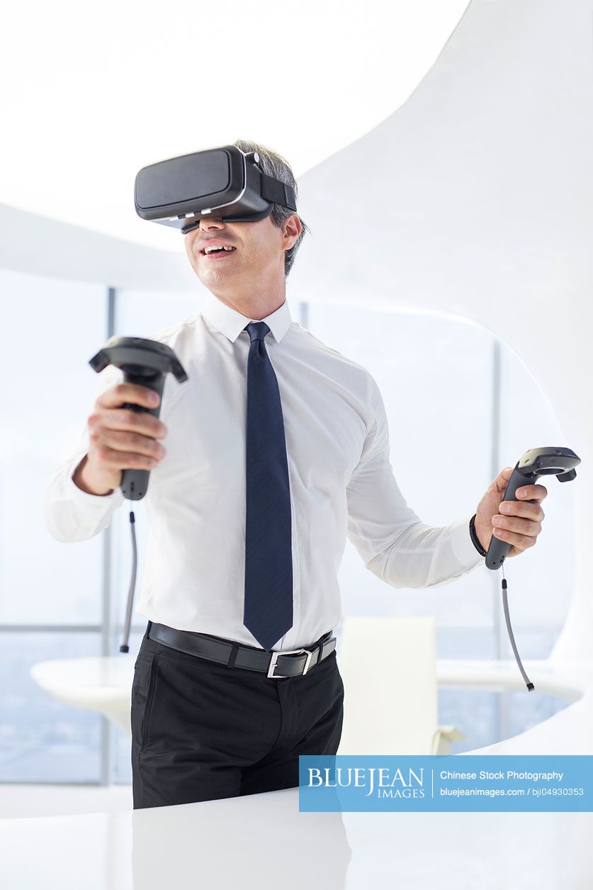 Businessman wearing VR glasses in office