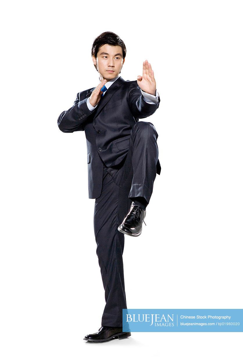 Chinese businessman in fighting stance with hands up