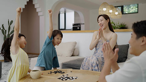 Family enjoying a game of Go in the hotel room