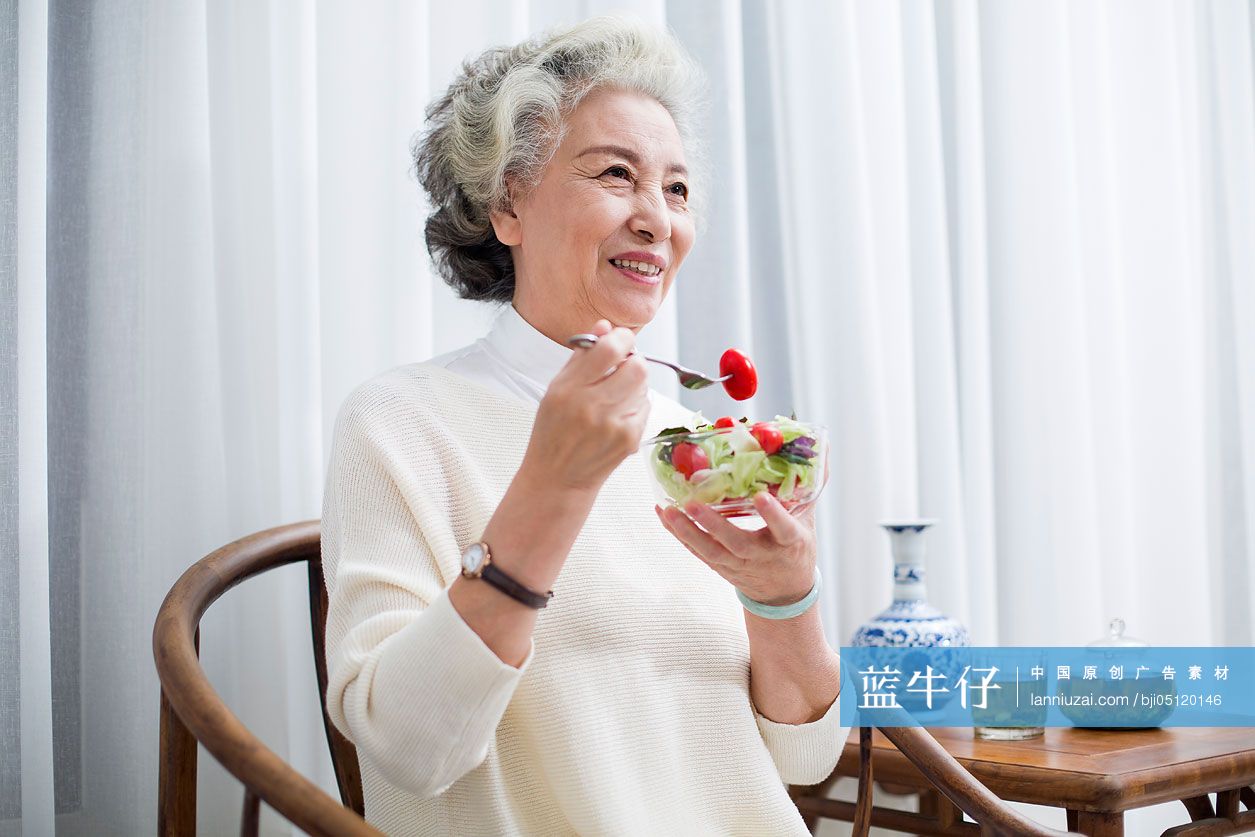 快乐的老年女子吃沙拉