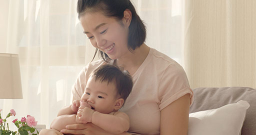 Young Chinese mom holding baby girl,4K