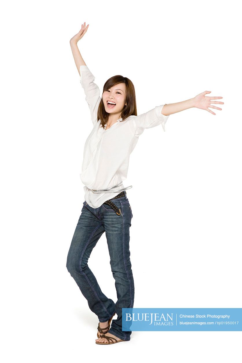 Portrait of young Chinese woman with arms outstretched