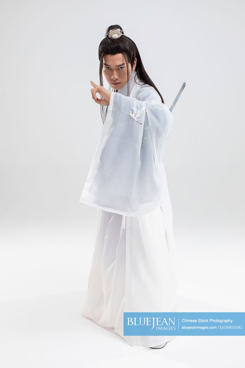 Young Chinese swordsman in ancient costume