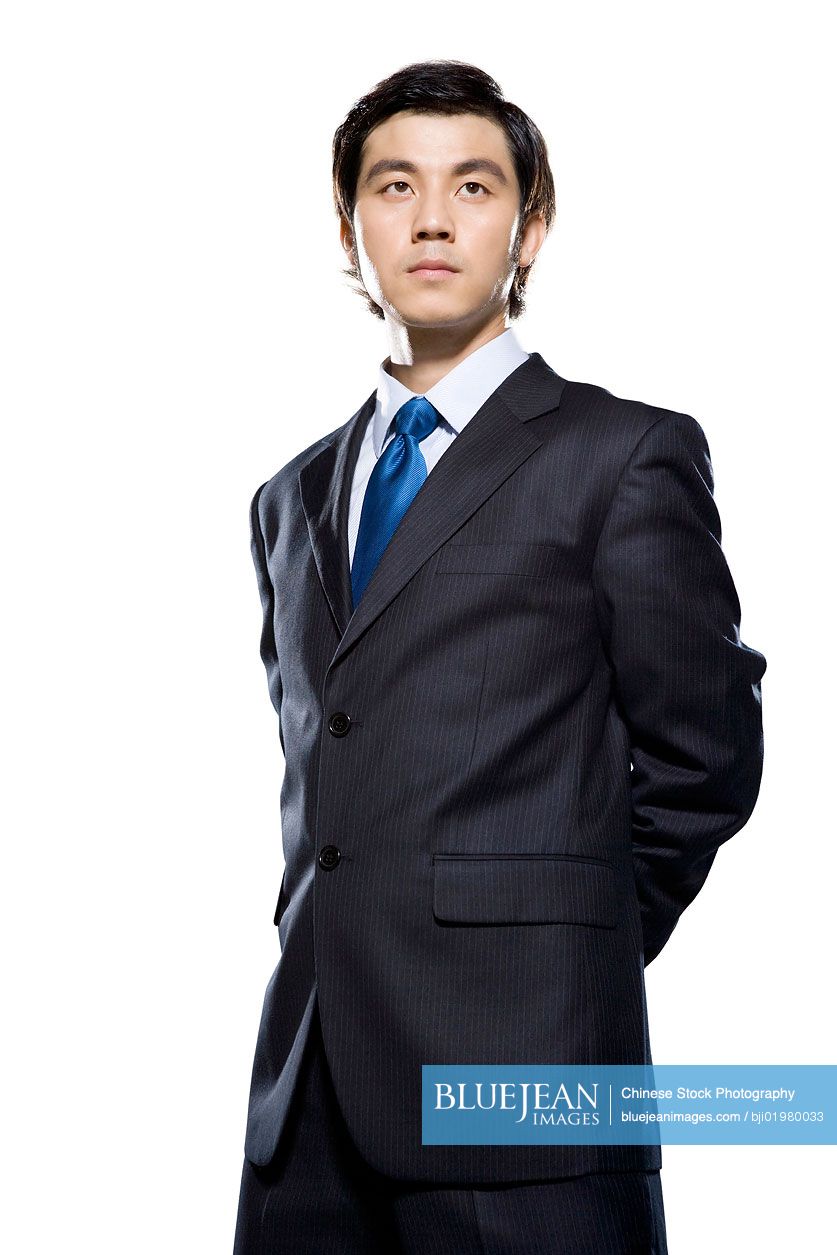 Chinese businessman looking off into distance on white background