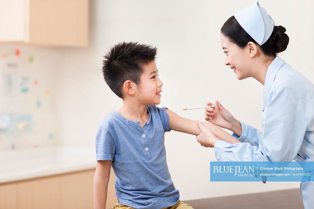 Chinese nurse giving boy injection