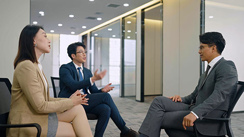 Chinese business people having meeting in empty office