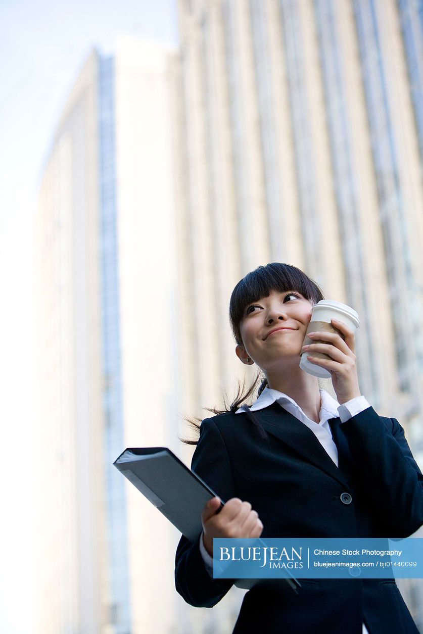 chinese-woman-with-coffee-and-documents-high-res-stock-photo-for-download