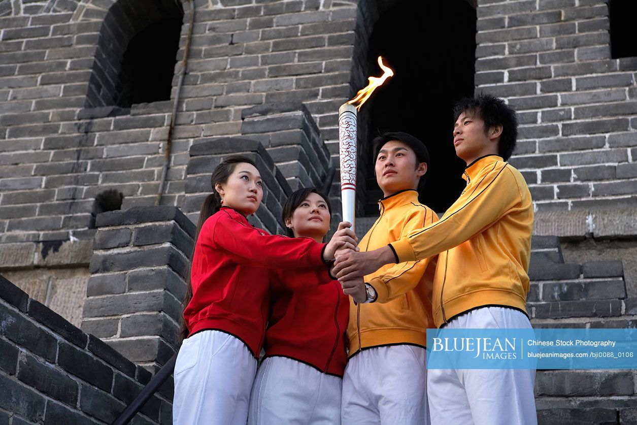 Two young Chinese couple performing the passing of the torch ceremony at the UNESCO world heritage site