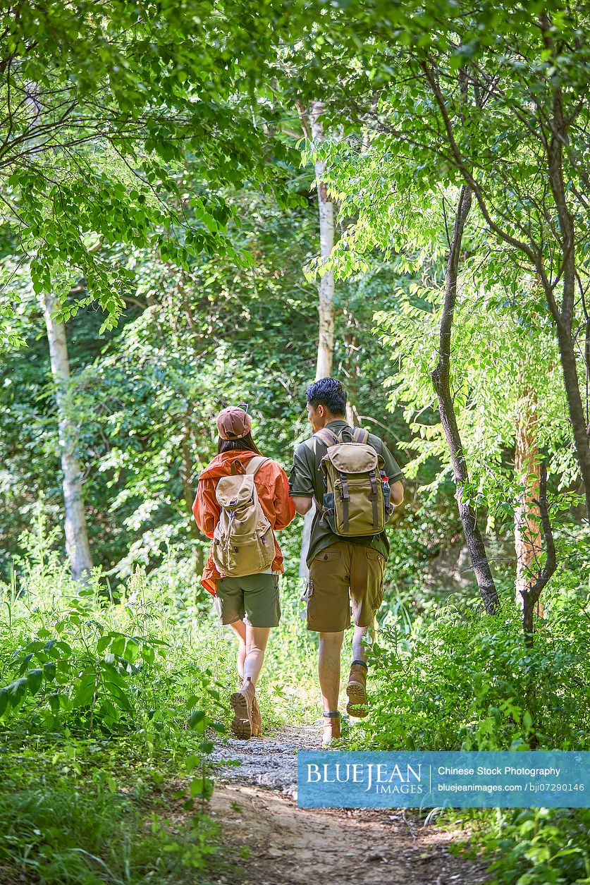 Happy couple hiking through the serene beauty of nature