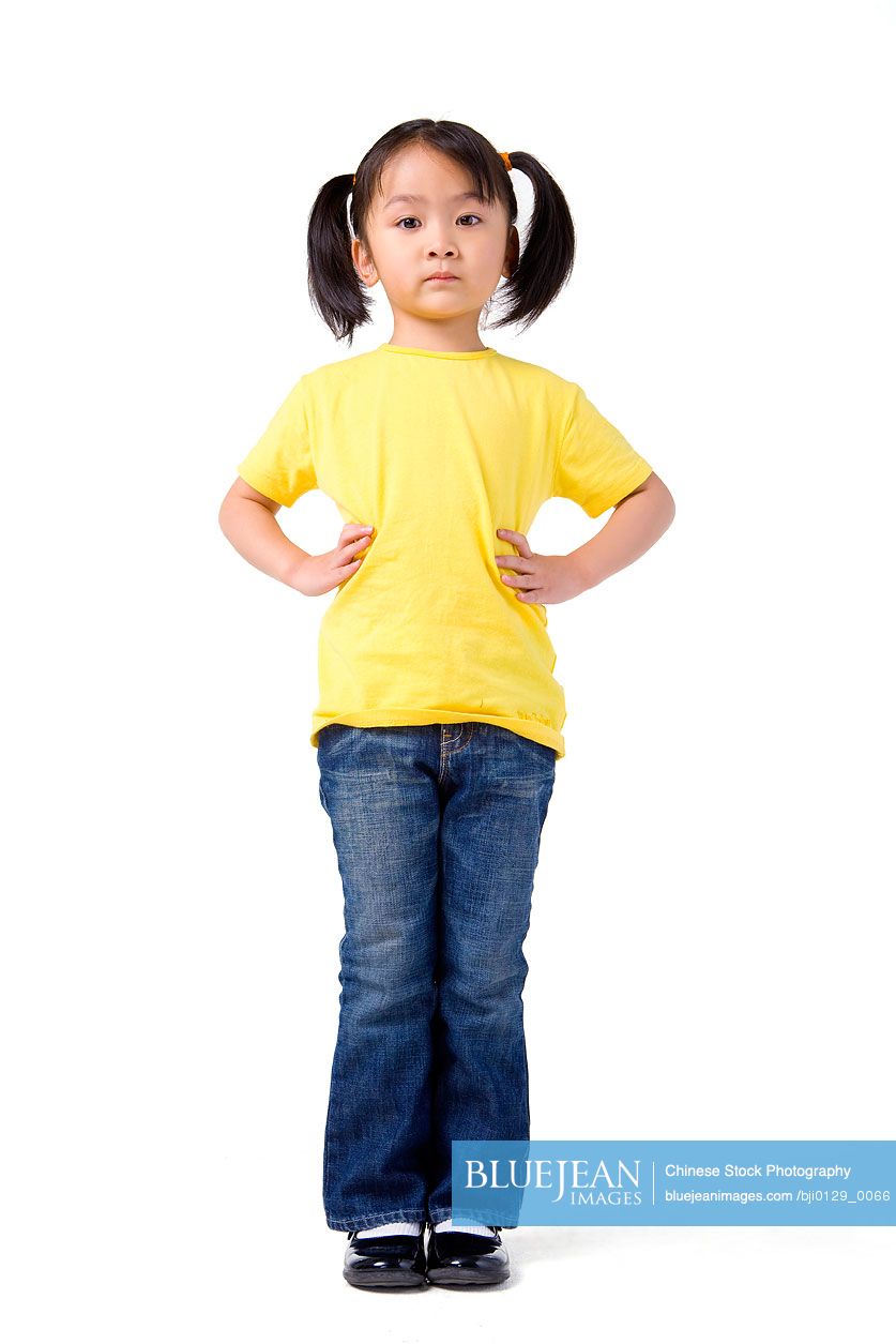 Little Chinese girl stands with her hands on her hips-High-res stock photo  for download