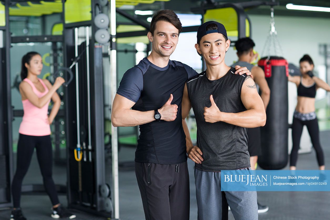 Portrait of young Chinese man and his personal coach