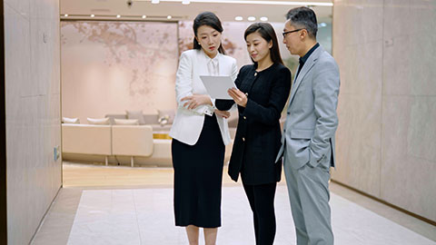 Confident Chinese business people talking in office