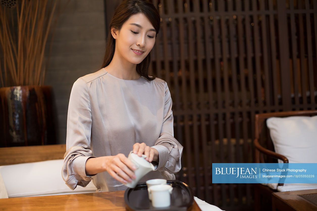 Young Chinese woman drinking tea