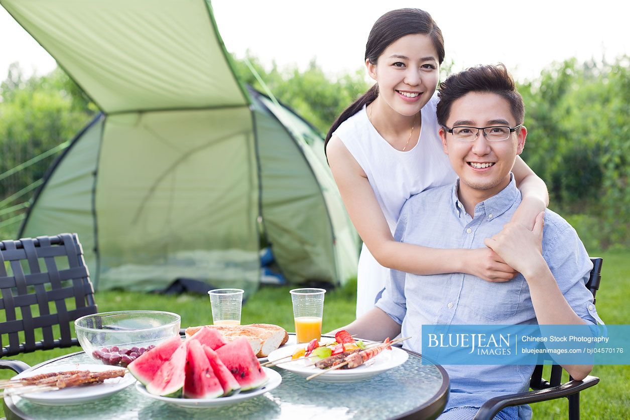 Young Chinese couple picnicking outdoors