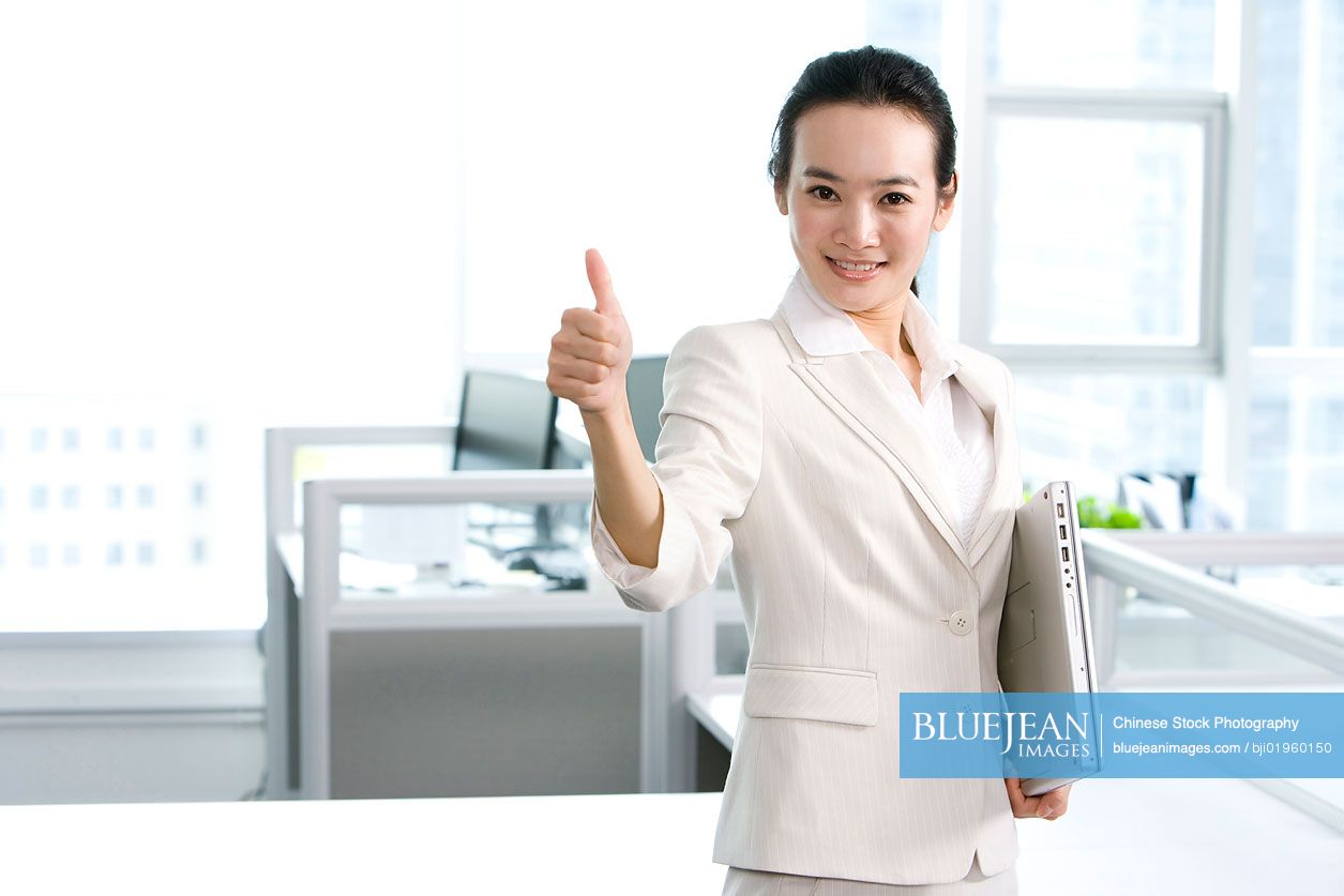 Chinese office worker giving thumbs up