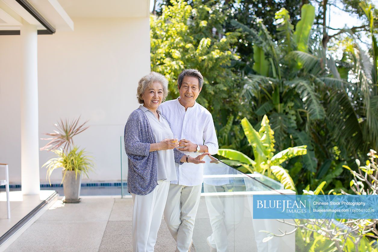Happy senior Chinese couple relaxing on balcony-High-res stock photo ...