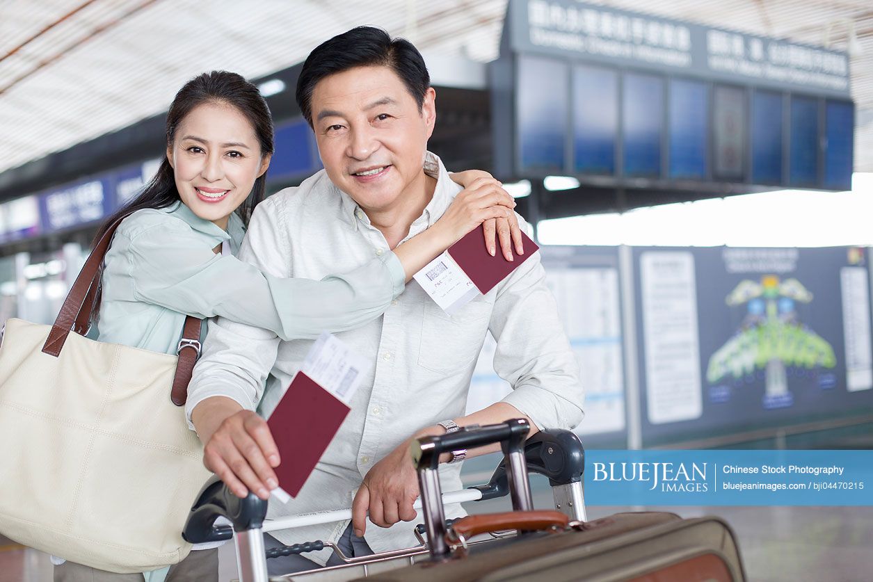 Mature Chinese couple waiting at airport