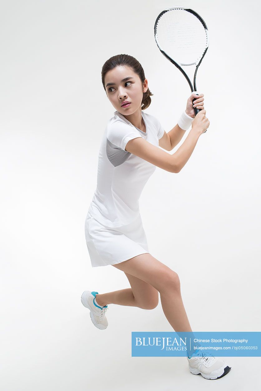 Young Chinese woman playing tennis