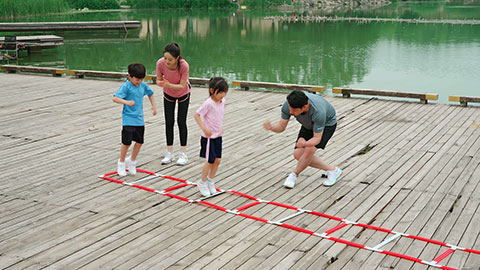A young family works out in the park, staying active and healthy