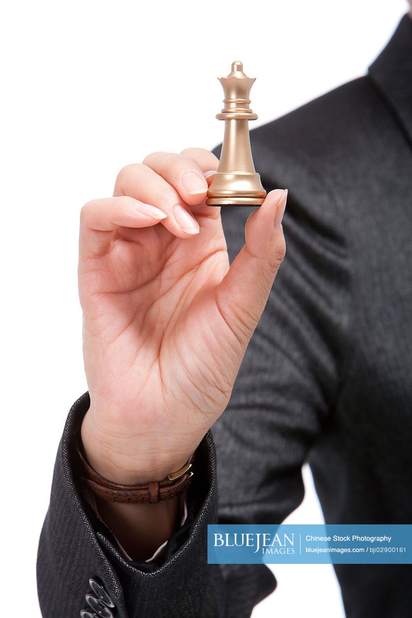 Chinese businesswoman holding a chess