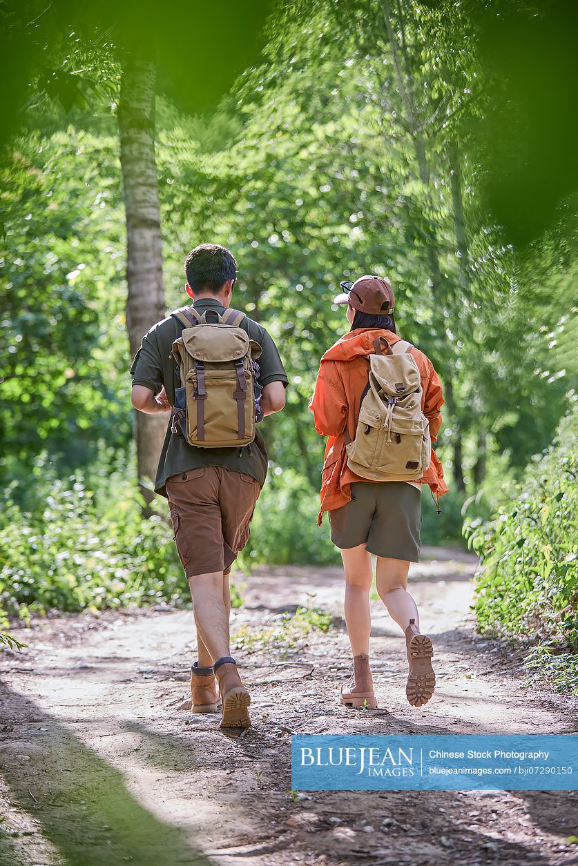 Happy couple hiking through the serene beauty of nature