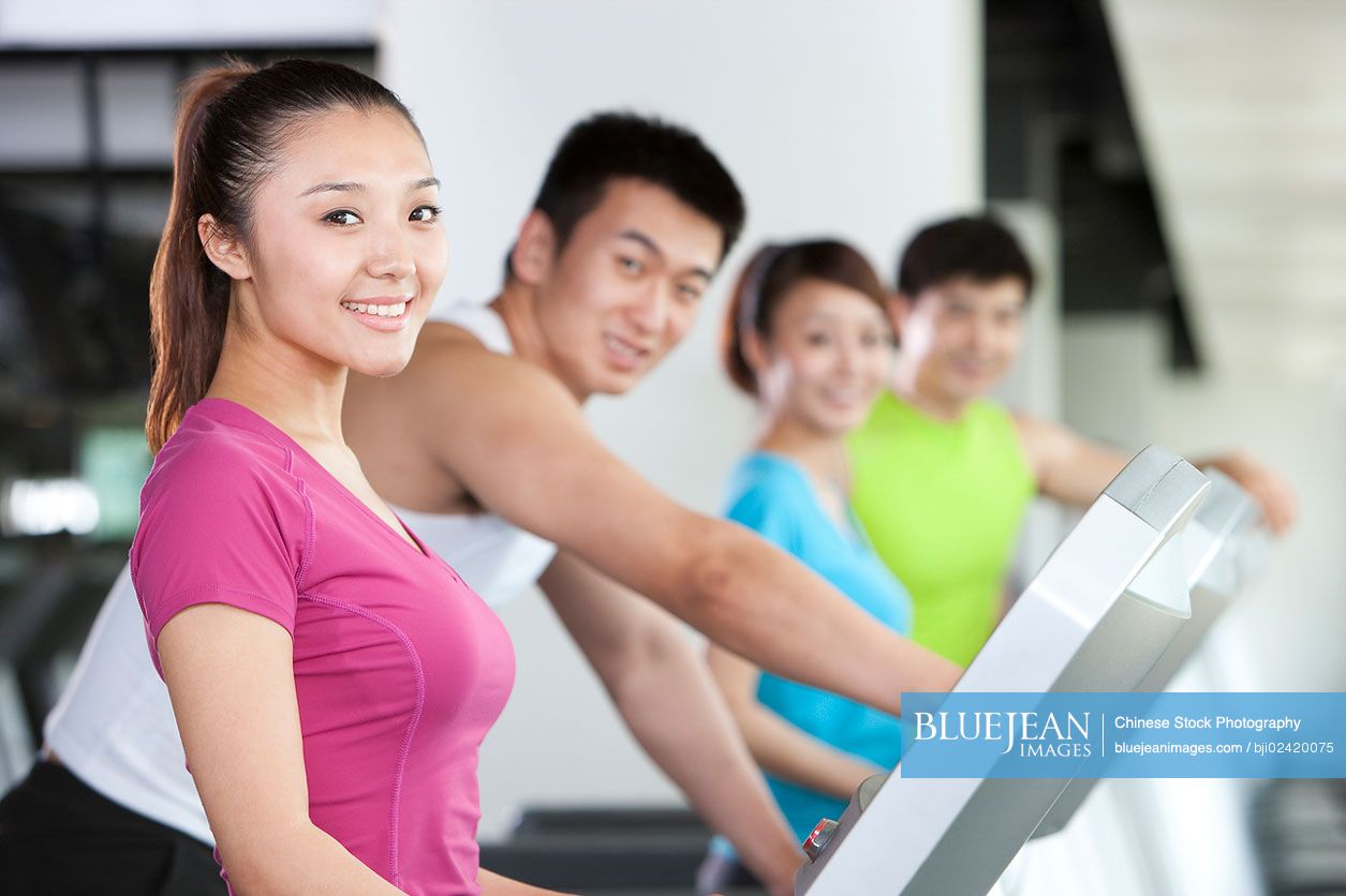 Four Chinese on treadmills