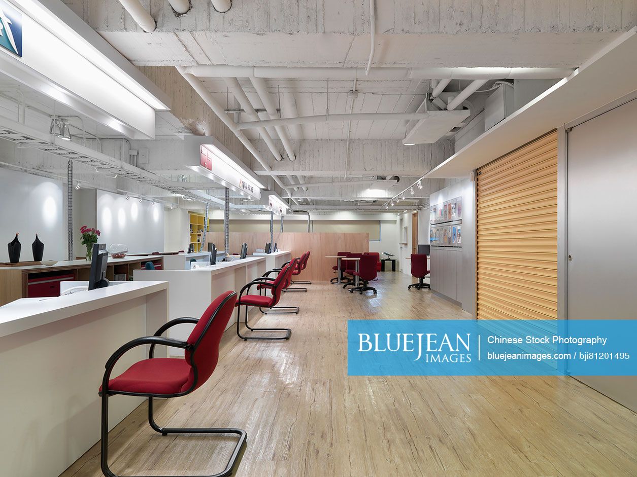 Row of desks and chairs in office