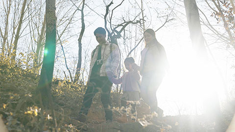 Happy young Chinese family hiking outdoors