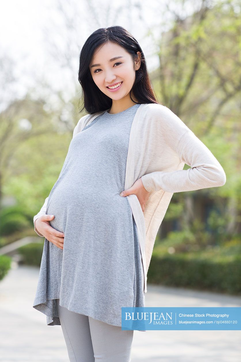 Portrait of happy pregnant Chinese woman