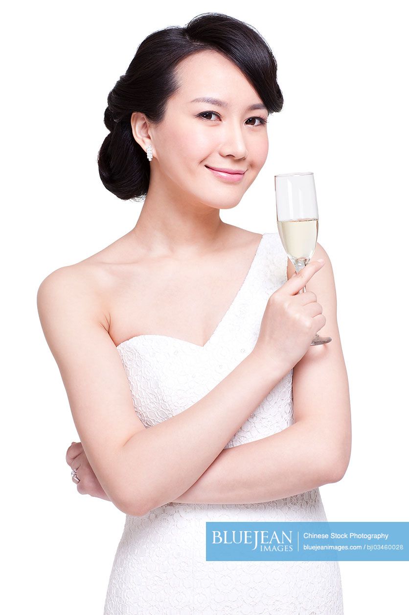 Graceful young Chinese woman with champagne flute