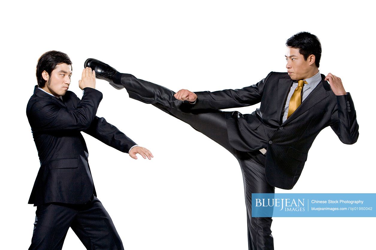 Two Chinese businessmen fighting on white background