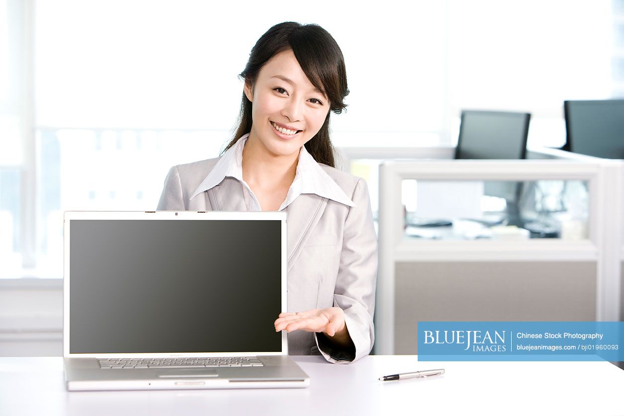 Chinese office worker at her desk