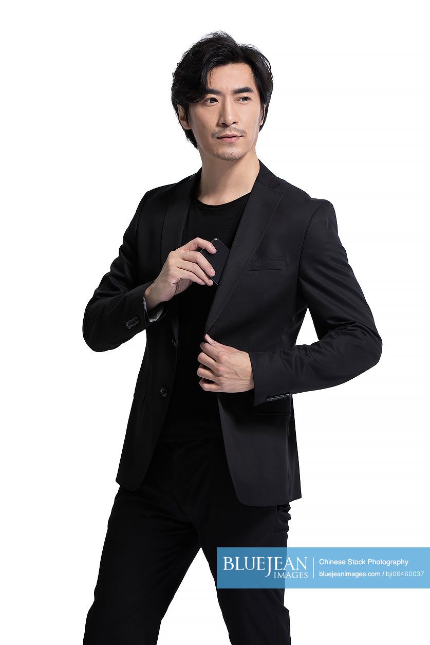 Studio shot of fashionable mid adult Chinese man