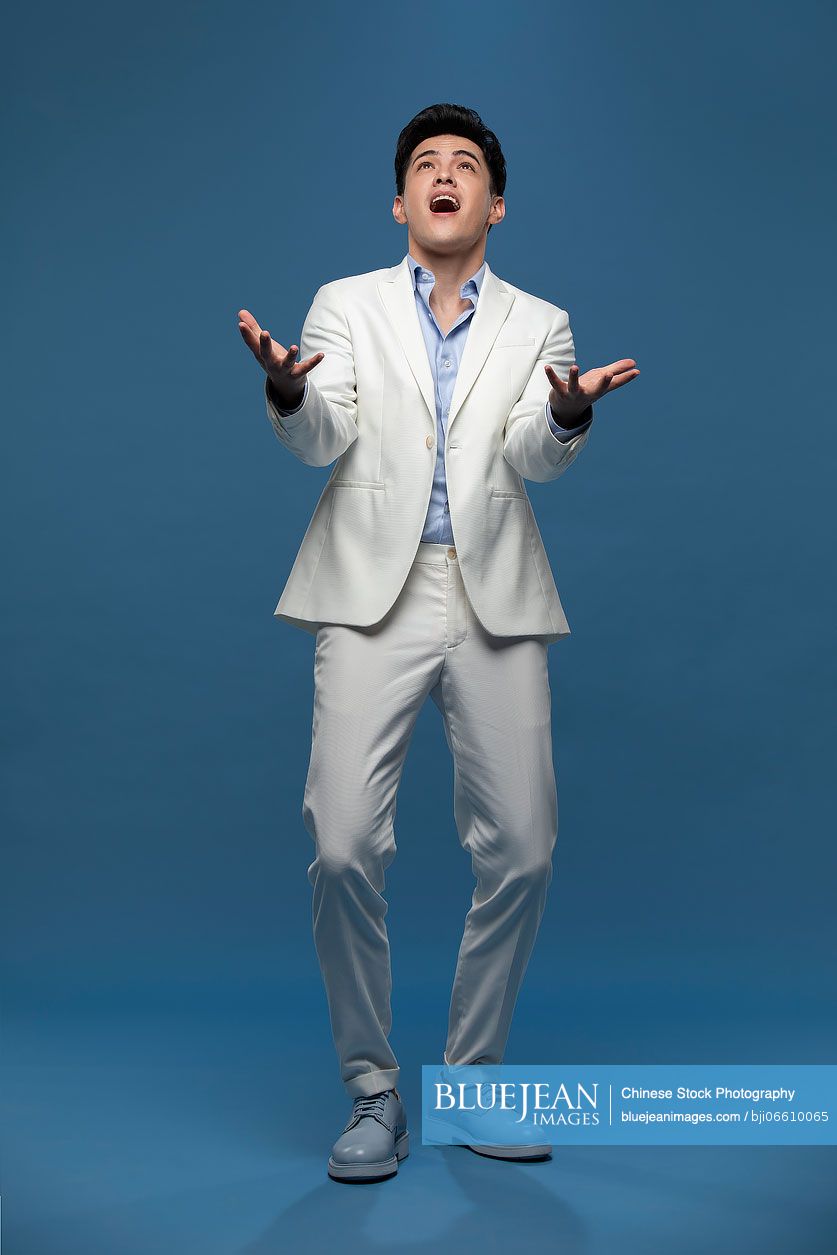 Studio shot of shocked young Chinese man