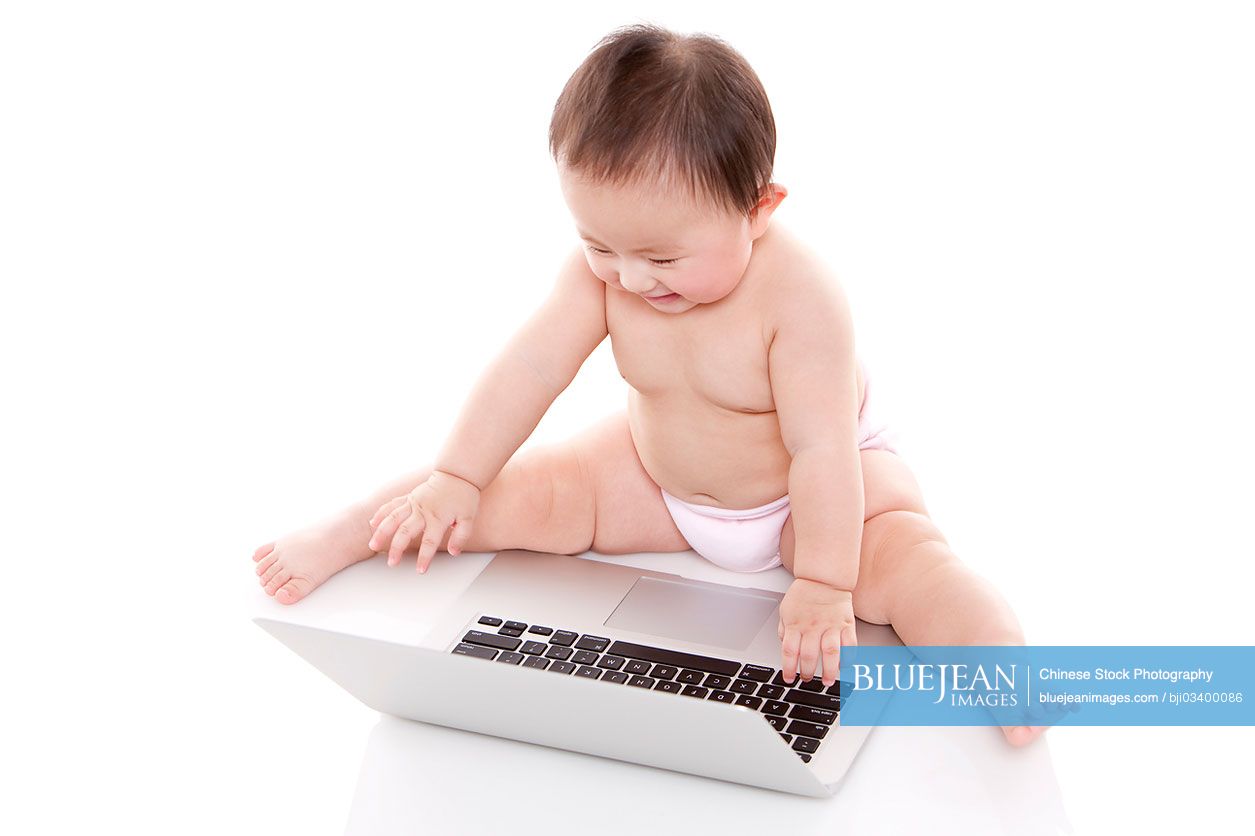 Cute Chinese baby girl with laptop