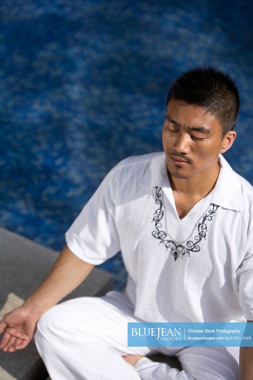 Chinese man meditating outdoors