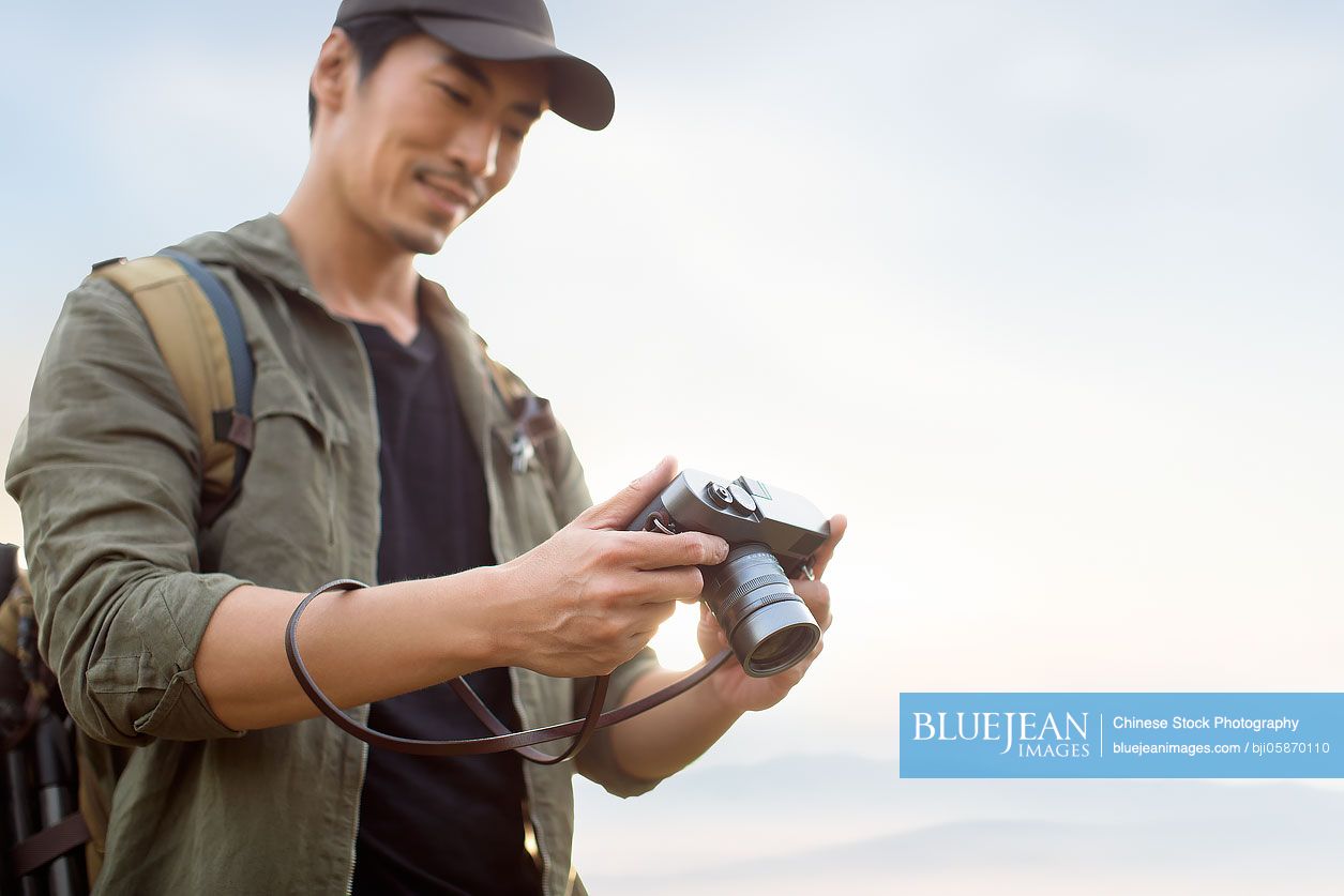 Chinese photographer taking photos outdoors