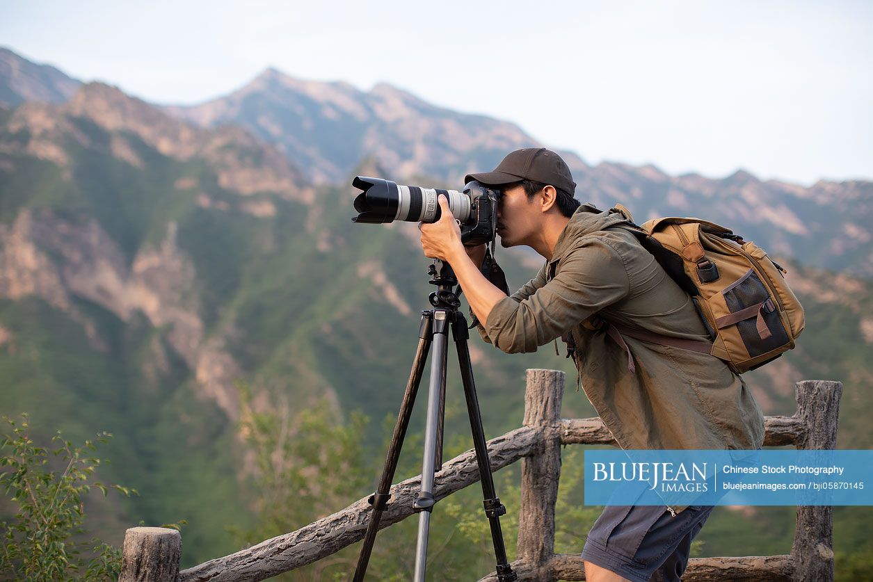 Chinese photographer taking photos outdoors