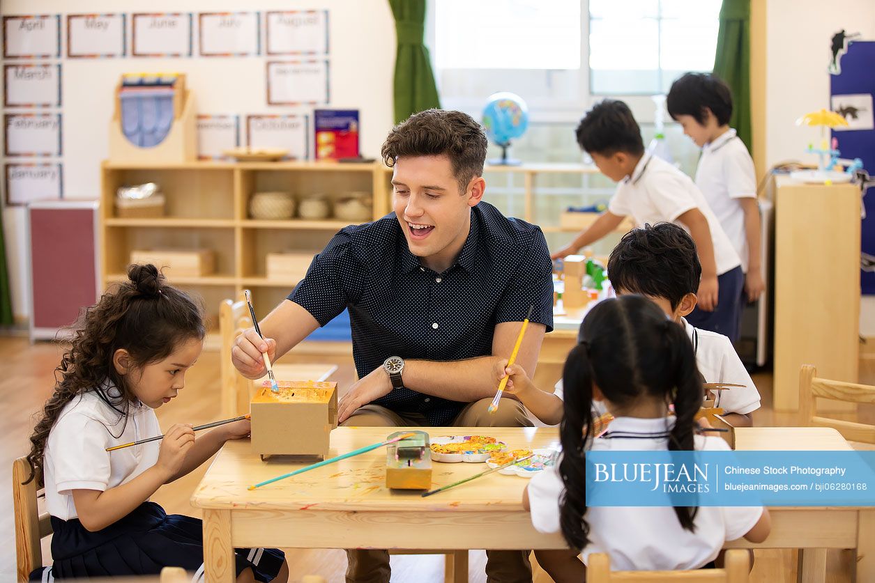 Foreign teacher teaching art class in classroom