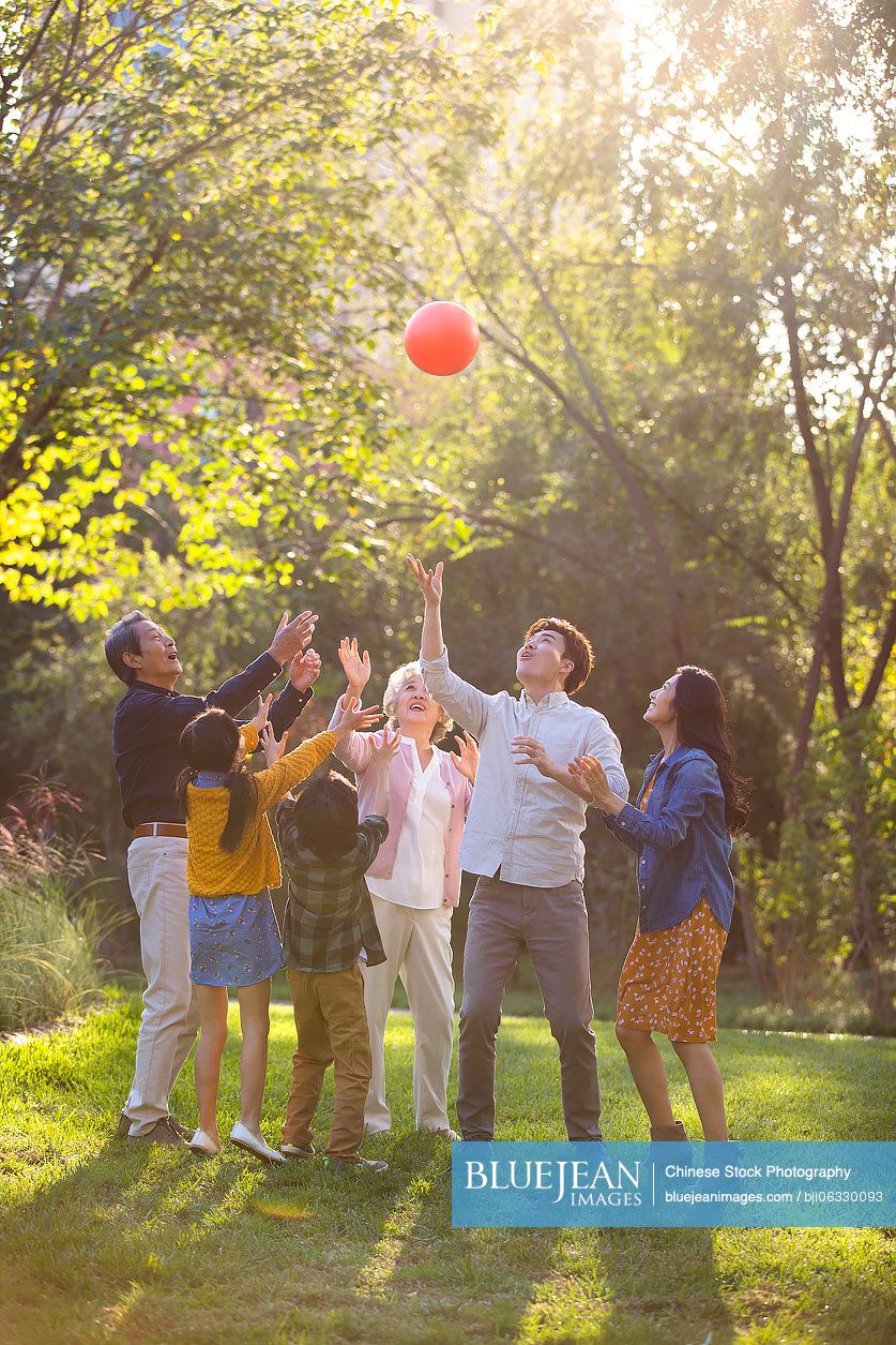 Happy Chinese family having fun in park