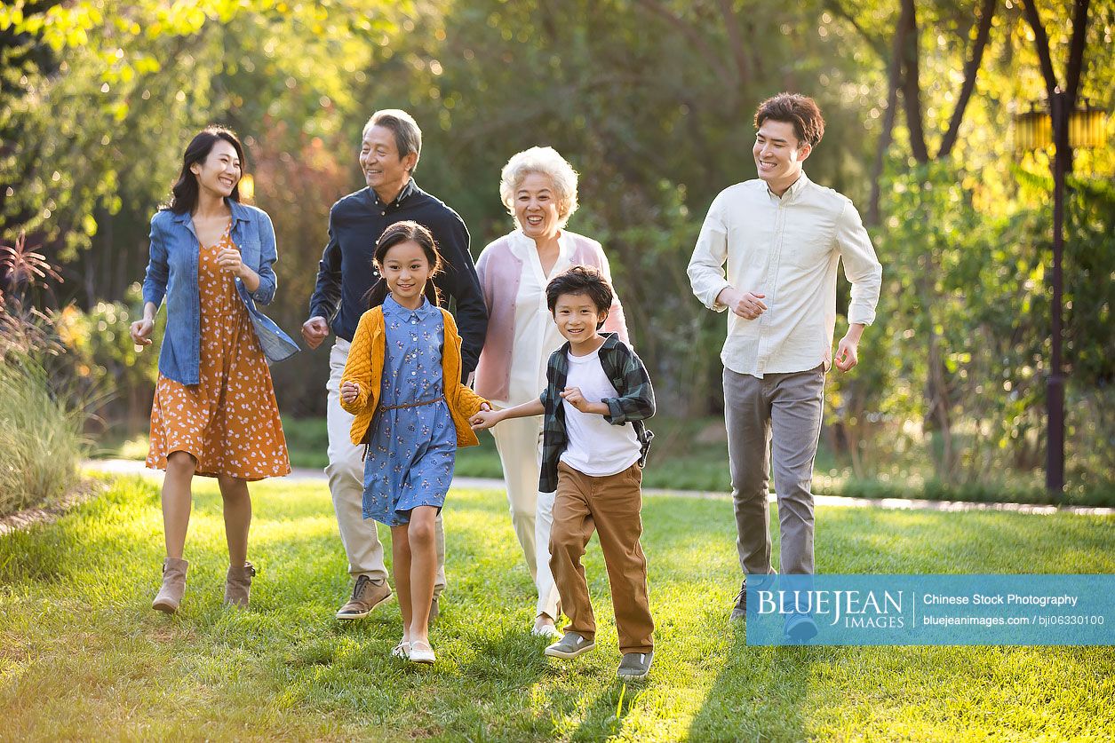Happy Chinese family having fun in park