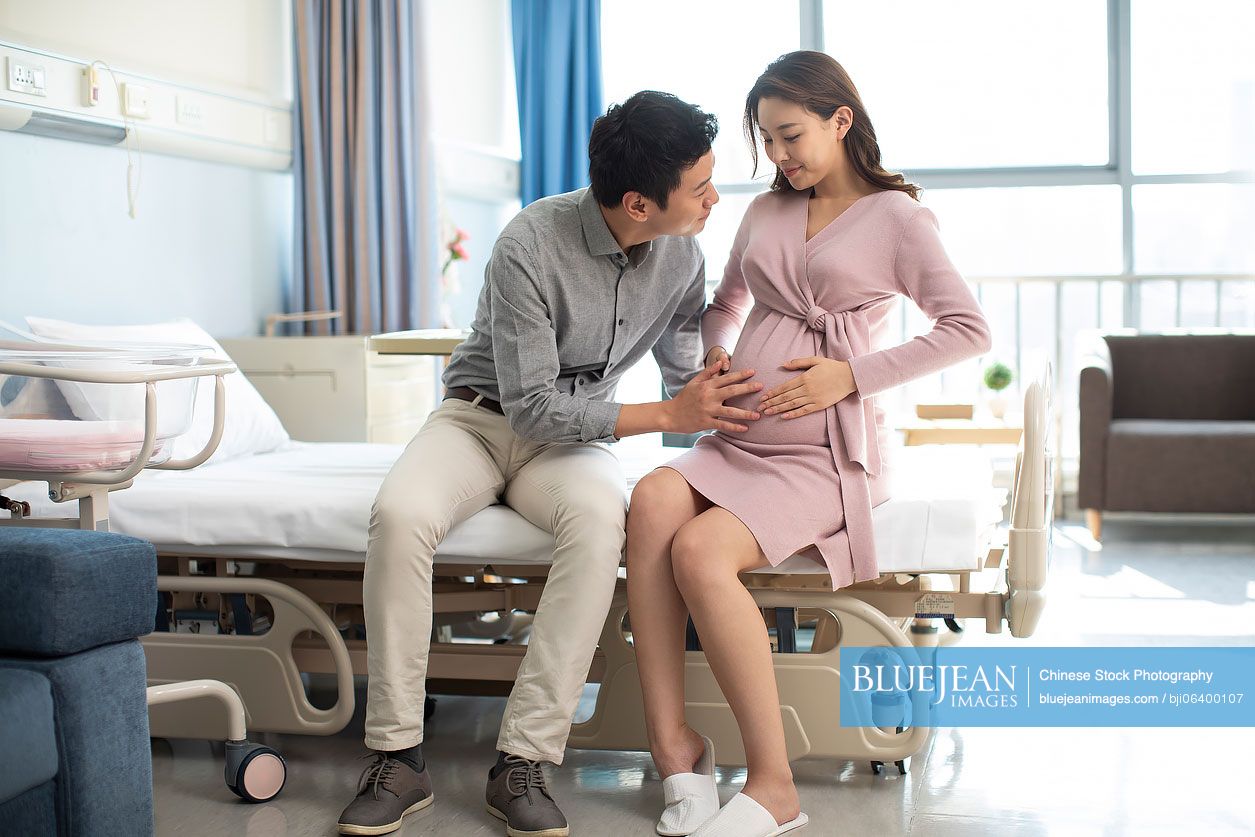 chinese-husband-touching-his-pregnant-wife-s-belly-in-hospital-ward