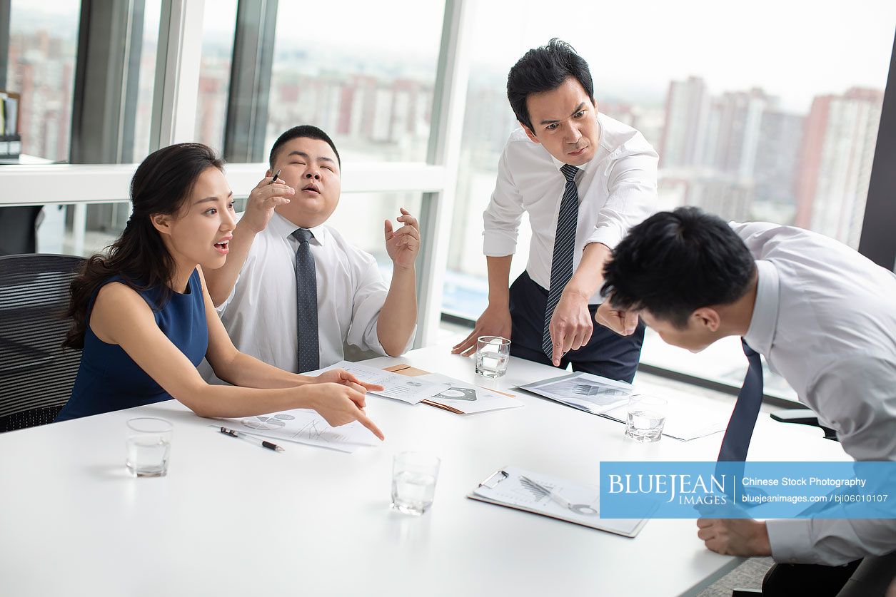 Chinese business people arguing in office