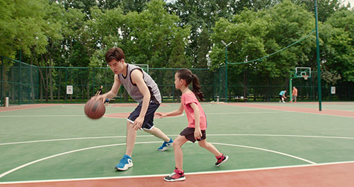 Chinese father and daughter playing basketball in park,4K