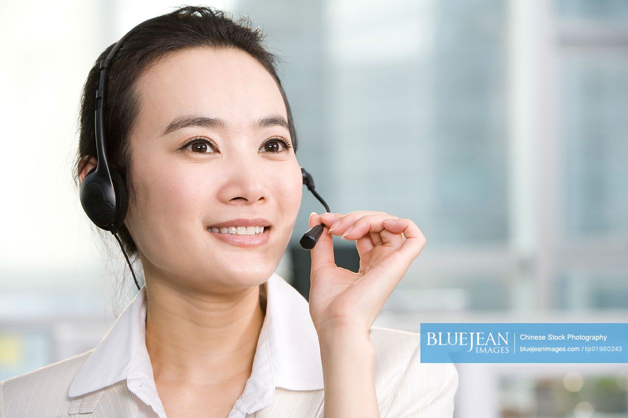 Chinese office worker with a headset