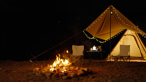 Illuminated tent and campfire