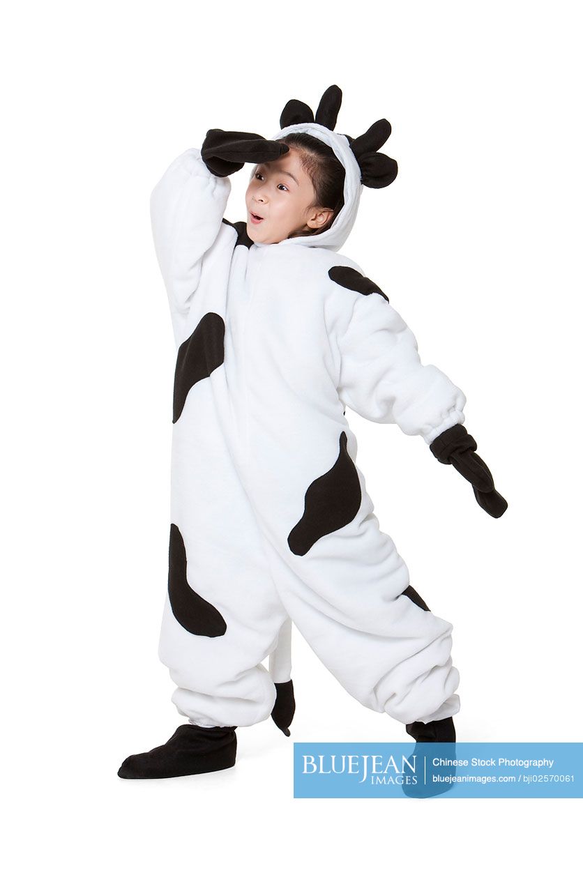 Cute Chinese girl in a cow costume playing