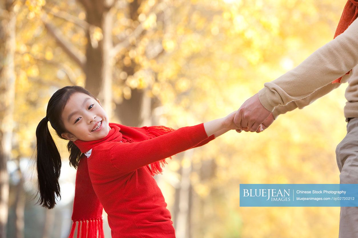 Chinese girl playing with her father