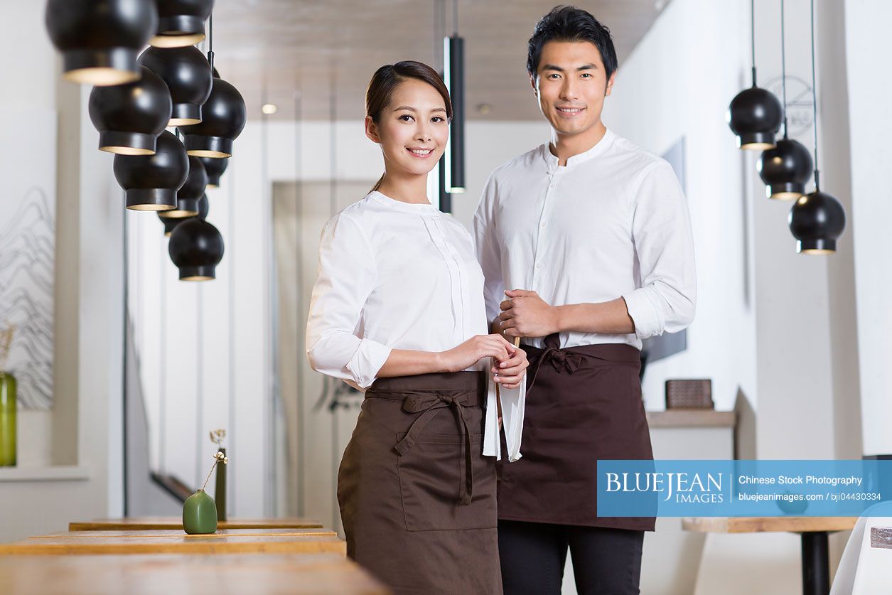 Chinese wait staff standing in restaurant